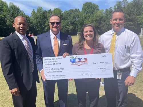 Rebecca Page with oversized check and prize patrol